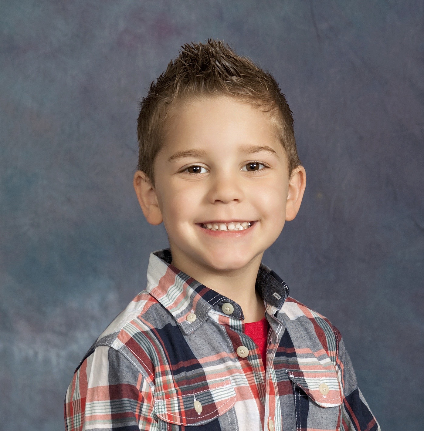 Portrait of a four-year-old boy with against a studio background. Model is smiling and quite happy. Standing.See other related images here: