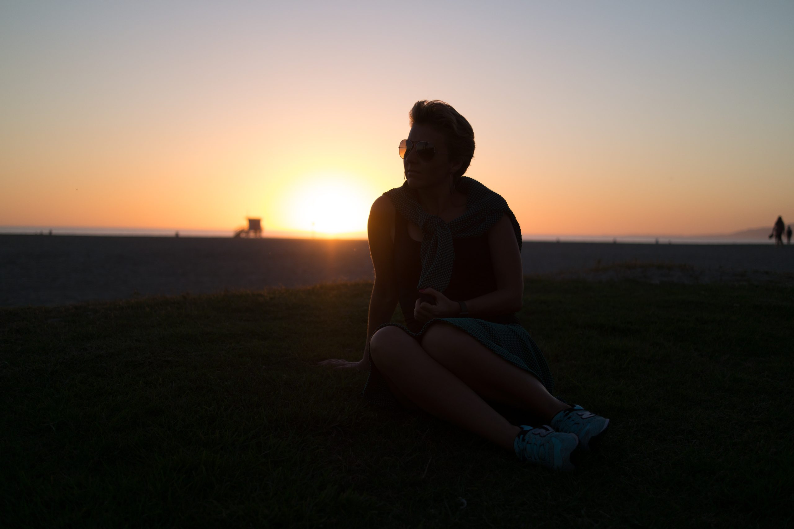 people,portr,noobj,middle,fem,outdoor,evening,lowl,noeyes,noteeth,glasses,facesh,backl,warml,sunset