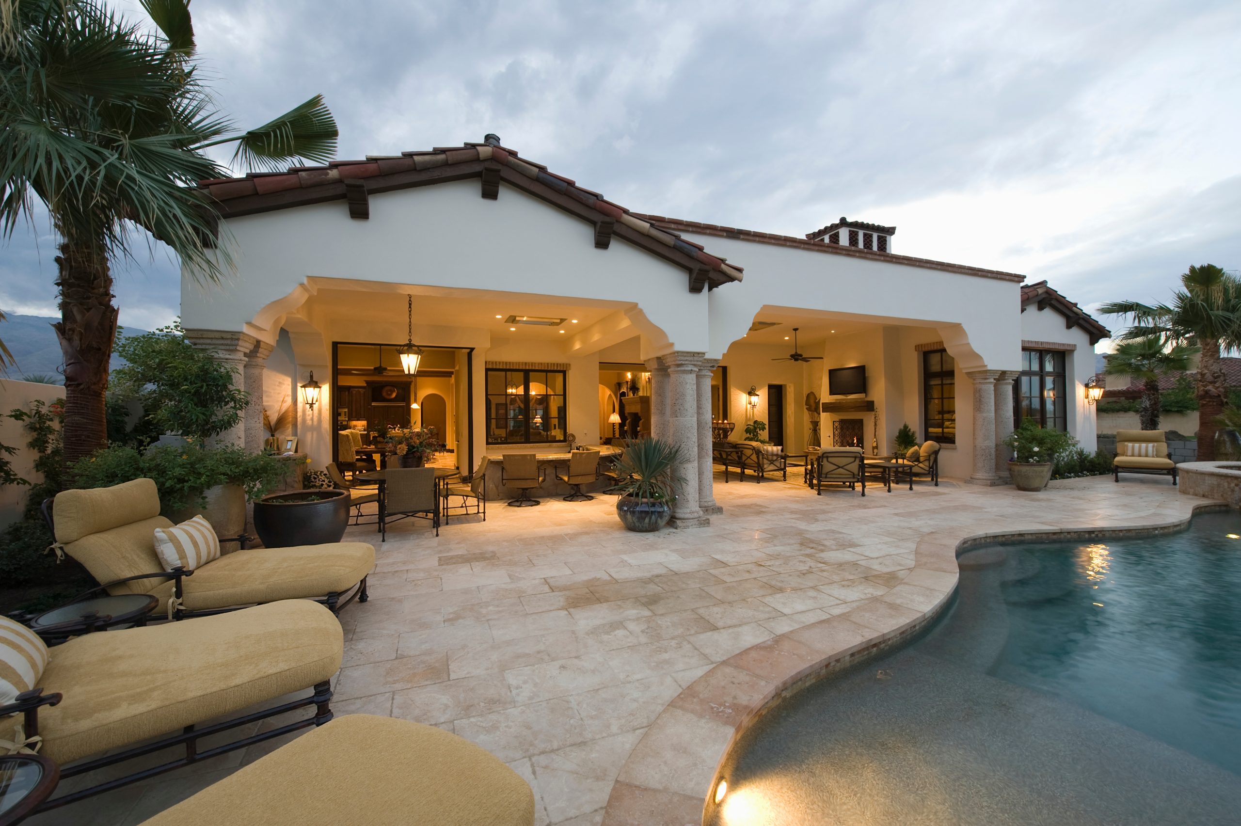 View of sunloungers by the pool against modern home