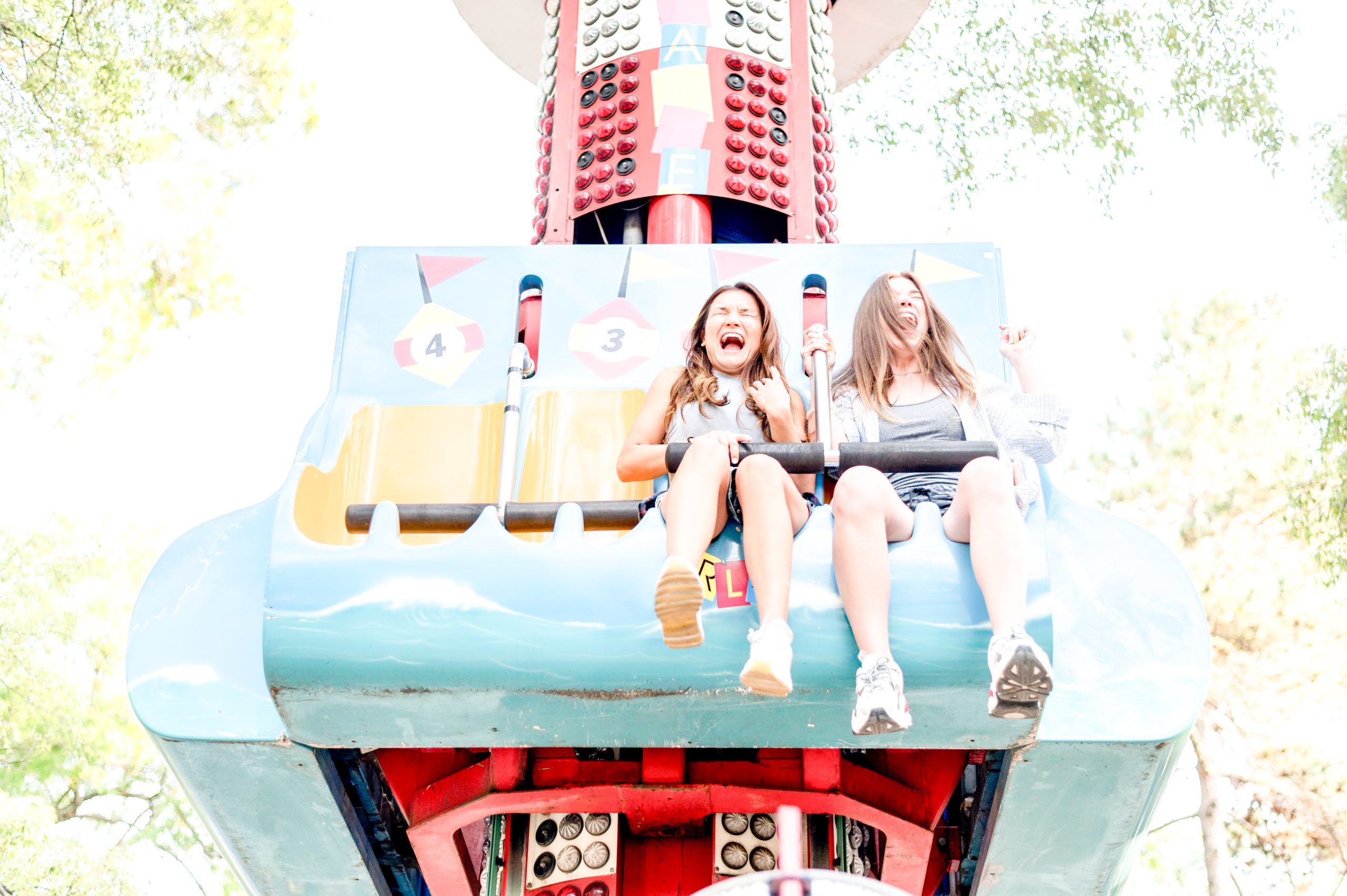 smiley-female-friends-having-fun-amusement-park-1-scaled.jpg