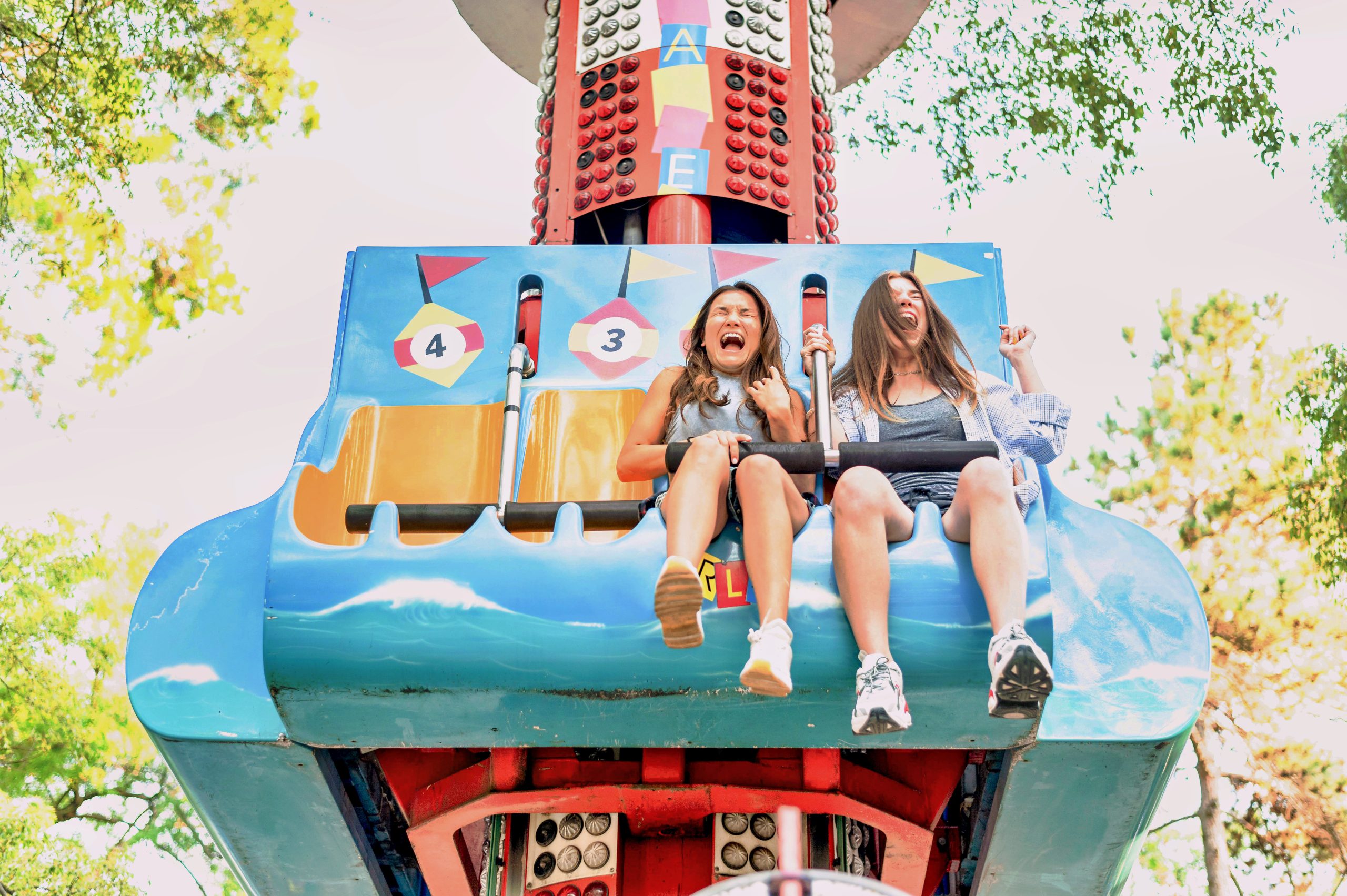 smiley-female-friends-having-fun-amusement-park_PfC_IAPPA_v1.0-scaled.jpg