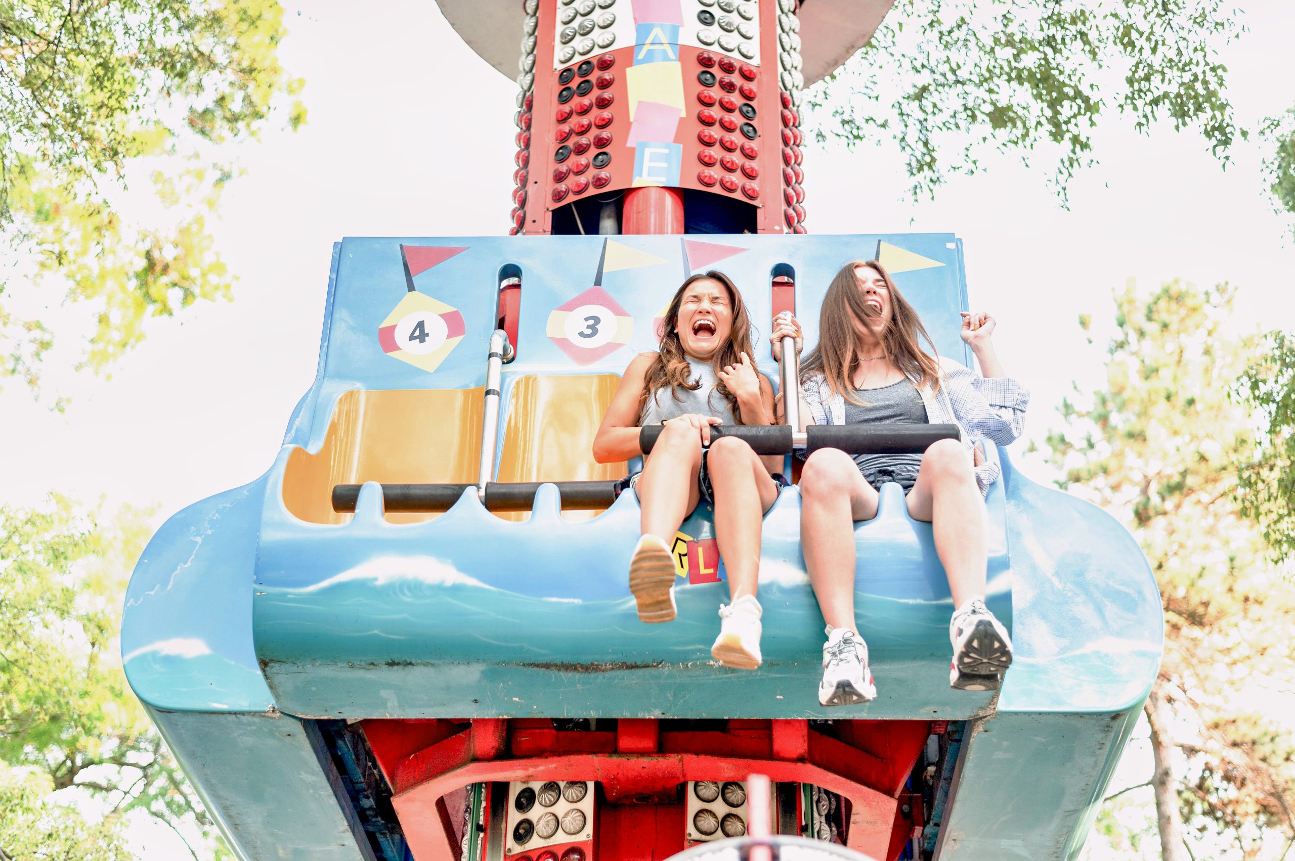 smiley-female-friends-having-fun-amusement-park_PfC_Pro-1-scaled.jpg